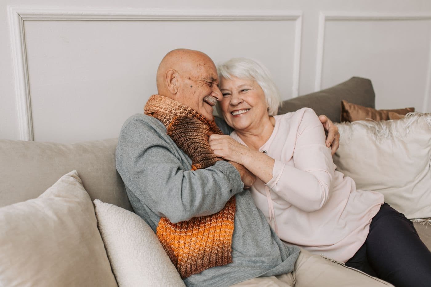 Older couple hugging on the sofa